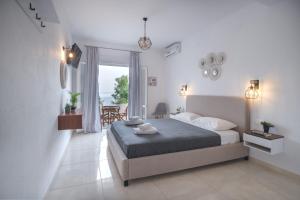 a bedroom with a bed and a large window at Pantheon in Patitiri