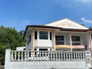a house with a balcony and a fence at Dino House in Taiping