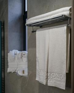 a bathroom with white towels on a towel rack at Richmond Hotel in Chişinău +60 photos
