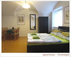 a bedroom with a bed and a dining room with a table at Apartmán U Kostela in Veselí nad Moravou