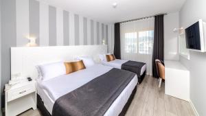 Кровать или кровати в номере Motto Premium Hotel&Spa