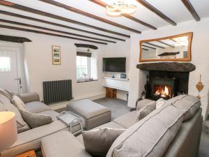 a living room with a couch and a fireplace at Sweetholme in Caernarfon