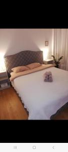 a large bed in a bedroom with a white bedspread at NEW BIG LOFT APARTMENTS JURMALA with FREE SECURED PARKING in Jūrmala