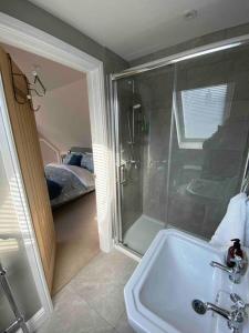 a bathroom with a shower and a sink at The Lodge in Birchington