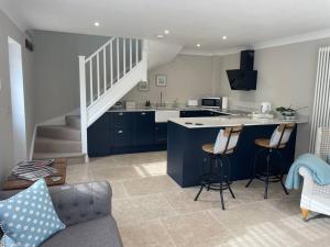 a kitchen with blue cabinets and a counter top at The Lodge in Birchington