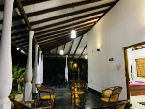 a group of chairs and tables on a patio at Garden Oasis with 1 Bedroom & 1 Bathroom in Batticaloa