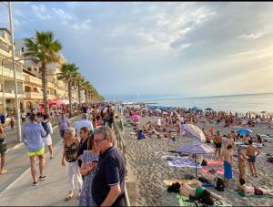 a large crowd of people on a beach at Civuleva! Casa vacanza Capo d Orlando in Capo dʼOrlando