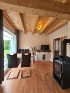 a living room with a fireplace and a stove at Ferienhuette in Altfriesack