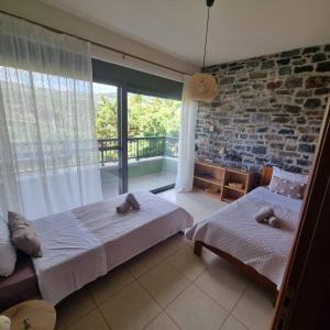 a bedroom with two beds and a brick wall at Villa Vigneto 