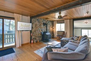a living room with a couch and a stone wall at The Woodland Cabin by Instant Suites - Old Village Mont-Tremblant in Mont-Tremblant