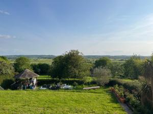 a park with a gazebo and a bench in a field at Glastonbury Vista in Glastonbury