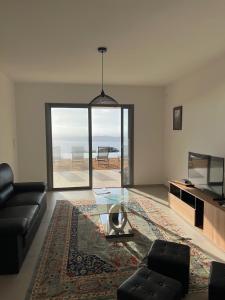 a living room with a couch and a glass table at Villa Cargese in Cargèse +42 photos