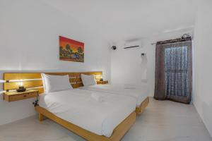 a bedroom with two beds and a window at Pool side Villa Zara in Albufeira