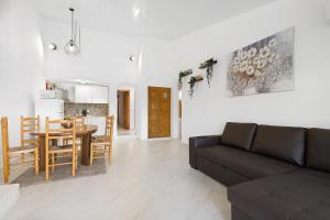 a living room with a couch and a table and a kitchen at Pool side Villa Zara in Albufeira