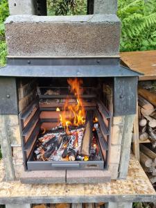 a fire in a stone oven with flames at Staubbachbänkli in Wengen
