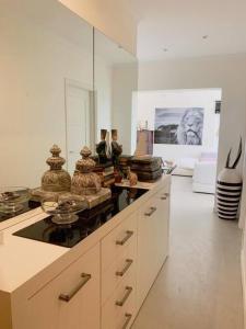 a kitchen with a counter with a large mirror at White shell vilamoura in Maritenda