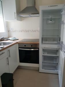 a kitchen with an empty refrigerator and a sink at Piedad Fernandez Fernandez Gestion de Inmuebles V in Barreiros