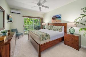 a bedroom with a bed and a window at Regency 220 in Koloa
