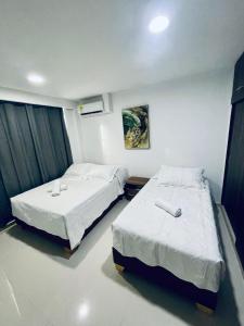 a room with two beds in a room at AMBAR CASA BOUTIQUE in San Andrés