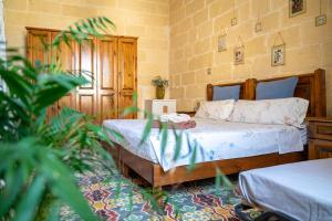 a bedroom with two beds in a room at Laremi Gozo B&B in Nadur