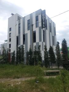 a building with a sign on the side of it at BS Hotel in Durrës
