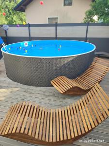 a hot tub with a wooden bench next to it at Berg & See Appartements in Hermagor