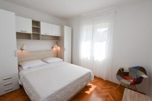 Postel nebo postele na pokoji v ubytování Apartments Guzela
