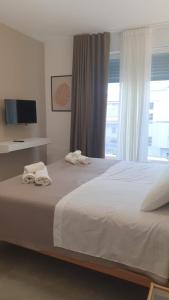 a bedroom with a large bed with towels on it at CASA DI PATTY in Bari Palese