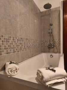 a bathroom with a bath tub with towels on it at L'appoggio perfetto in Viareggio