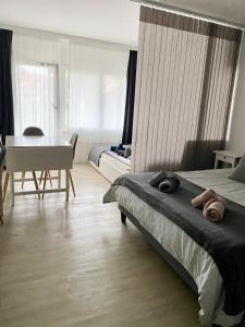 a bedroom with a bed and a table and a desk at Studio 4pers aux Bains de Saillon in Saillon +18 photos