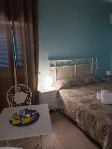a bedroom with a bed and a table with a plate on it at B&B Casa Tropea in Tropea