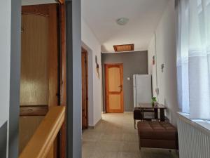 a hallway with a living room with a table and a refrigerator at Vila Mondi in Eforie Nord