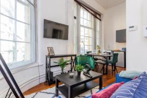 a living room with a couch and a table at Newcastle's Most Central Apartment - Sleeps 10 in Newcastle upon Tyne
