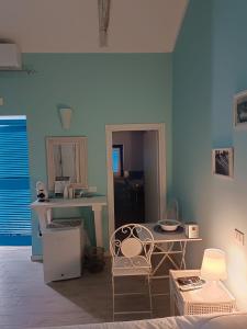 a blue room with a table and a chair at B&B Casa Tropea in Tropea