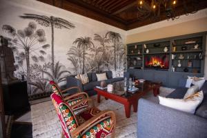 a living room with a couch and a fireplace at Villa May sur le Golf de la Palmeraie with Cooker and Butler included in Marrakech