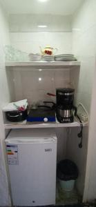 a small kitchen with a stove and a pot on a shelf at Studio avec piscine et parking prive in Fez