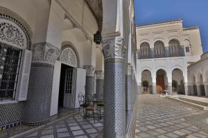 a courtyard of a building with columns and a gate at Studio avec piscine et parking prive in Fès