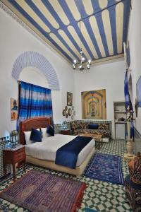 a bedroom with a bed and a living room at Studio avec piscine et parking prive in Fez