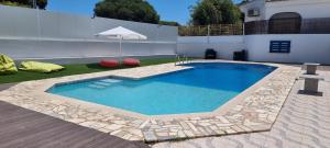 a swimming pool in the yard of a house at Hospedaria do Almargem in Quarteira +25 photos