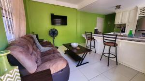 a living room with a couch and a kitchen at Caribbean Dream Vacation Property CD2 in Rodney Bay Village
