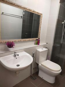 a bathroom with a sink and a toilet and a mirror at MyHome 2B At Seri Kembangan With A View in Seri Kembangan