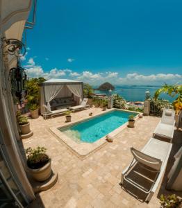 a swimming pool on a patio with a view of the ocean at Villa Caprichosa in Taboga