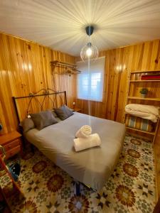 a bedroom with a bed with a towel on it at Kitecamp Tarifa in Tarifa