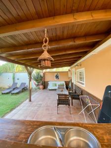 a patio with a table and chairs and a chandelier at Kitecamp Tarifa in Tarifa