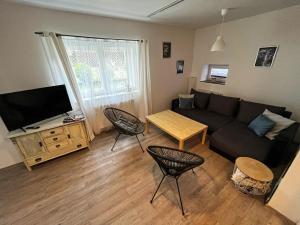 a living room with a couch and a table at Apartmán Štolbova in Pardubice