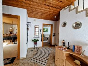 a living room with a wooden ceiling at Ferienhaus Anni Rödental in Rödental