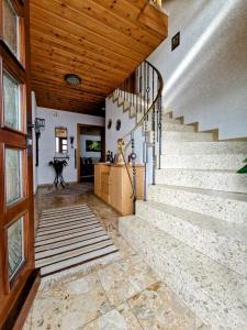 a staircase in a house with a wooden ceiling at Ferienhaus Anni Rödental in Rödental