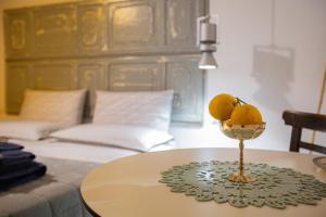 a table with a bowl of lemons on top of it at Casuzza al Duomo con vista Valle dei Templi! in Agrigento