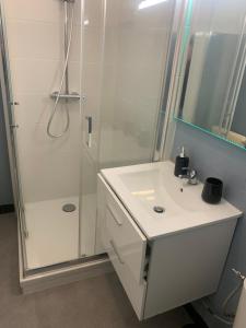 a bathroom with a white sink and a shower at Location 2 pers centre historique de quimper in Quimper