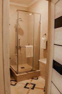 a shower with a glass door in a bathroom at Aura Almaty in Almaty
